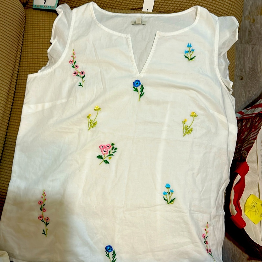 White with some embroidery no sleeve cotton very soft